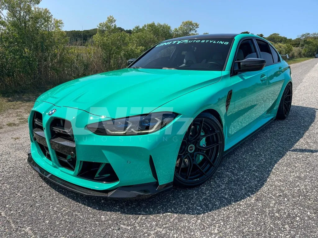 Teal BMW G80 M3 with a carbon OEM++ SPL1 front lip, front three-quarter view