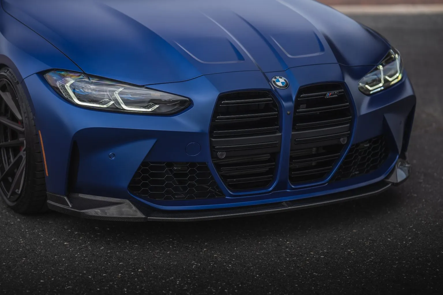 Blue BMW G82 M4 front end, low angle