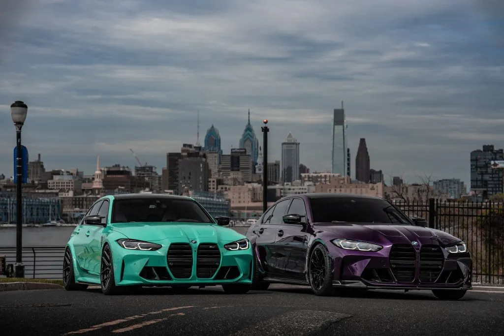 Teal and purple G80 M3s on the waterfront