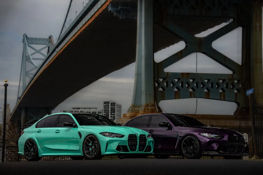 Teal and purple G80 M3s under the bridge