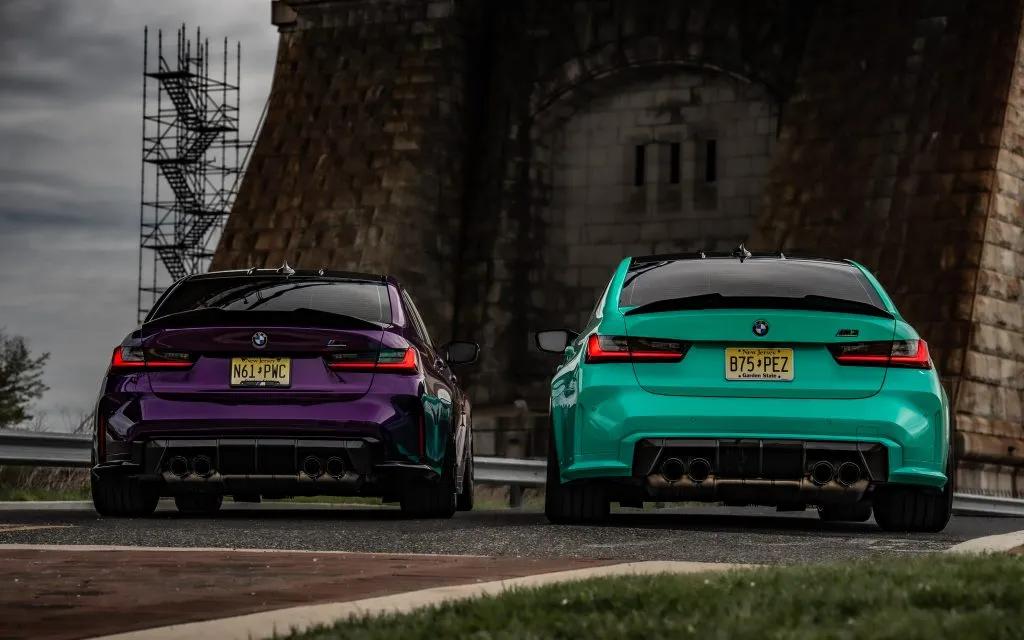 Purple and teal G80 M3s from behind