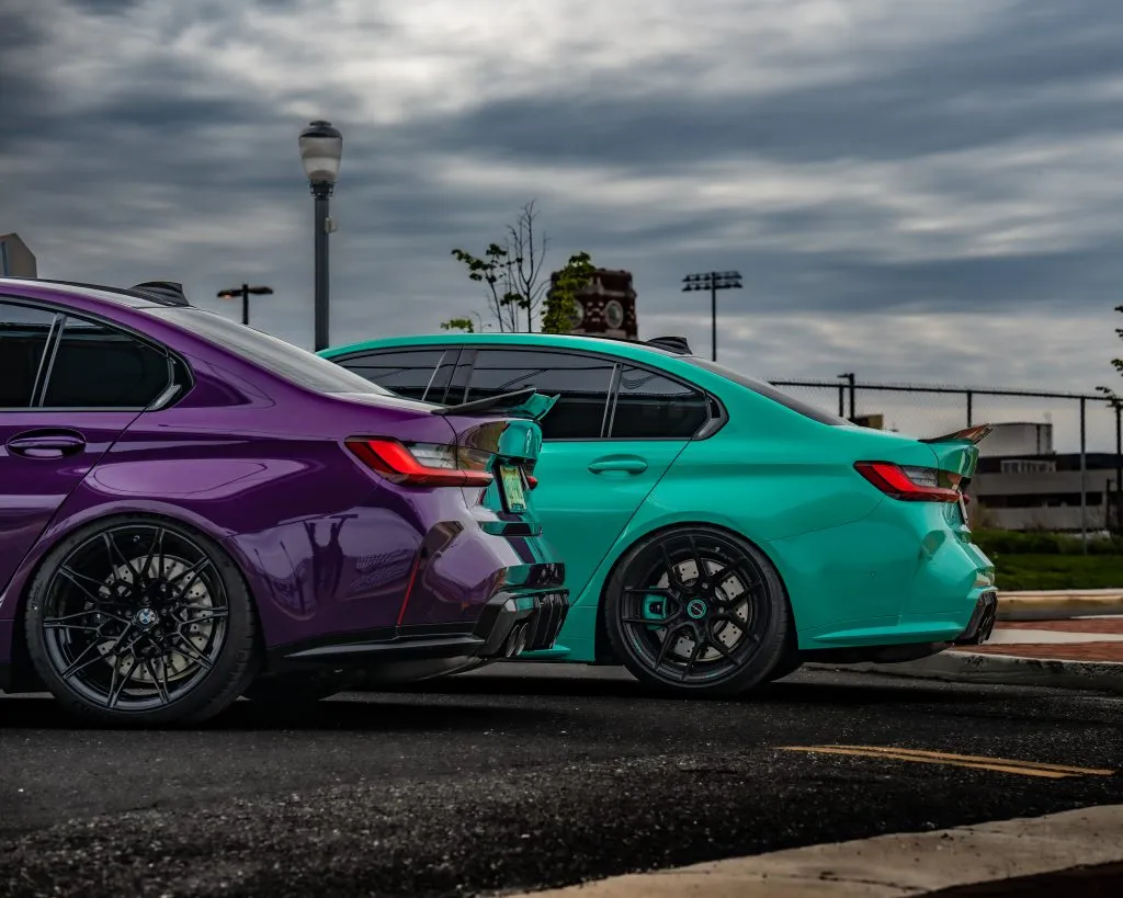 Purple and teal G80 M3s side by side