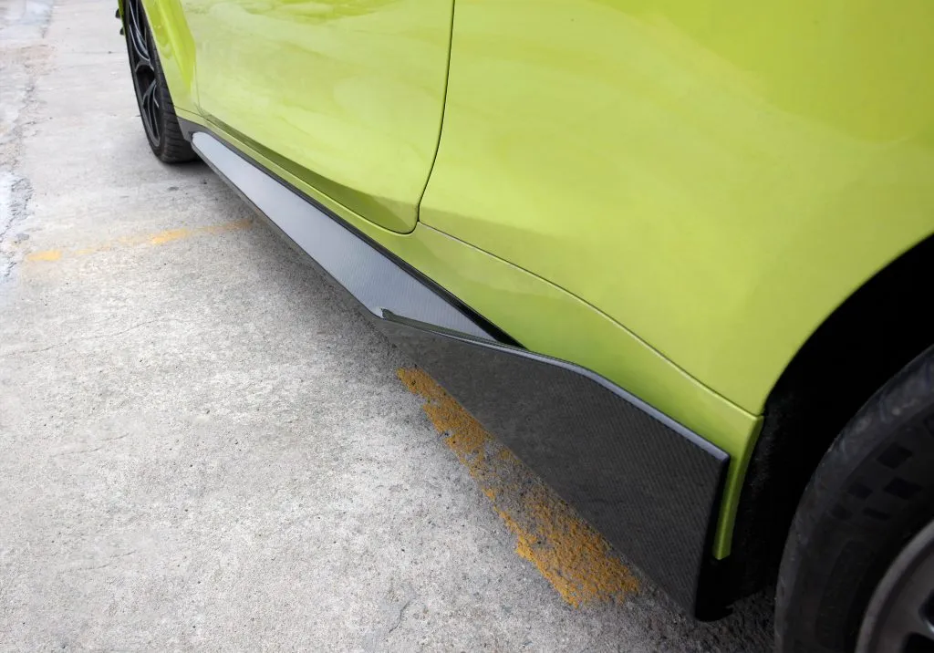 BMW G82 M4 MP style prepreg dry carbon fiber full replacement side skirts with gloss finish w/winglet — image 4 of 12