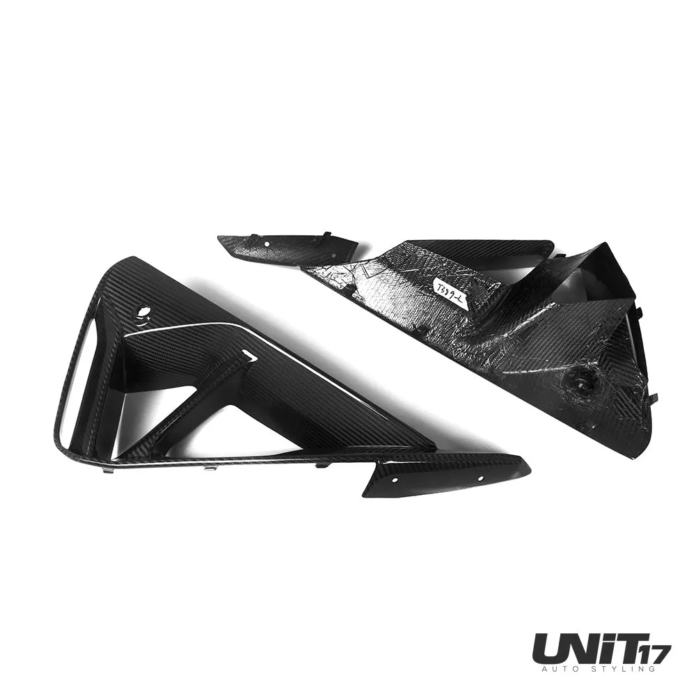 Front and rear surfaces of the carbon ducts with mounting tabs visible