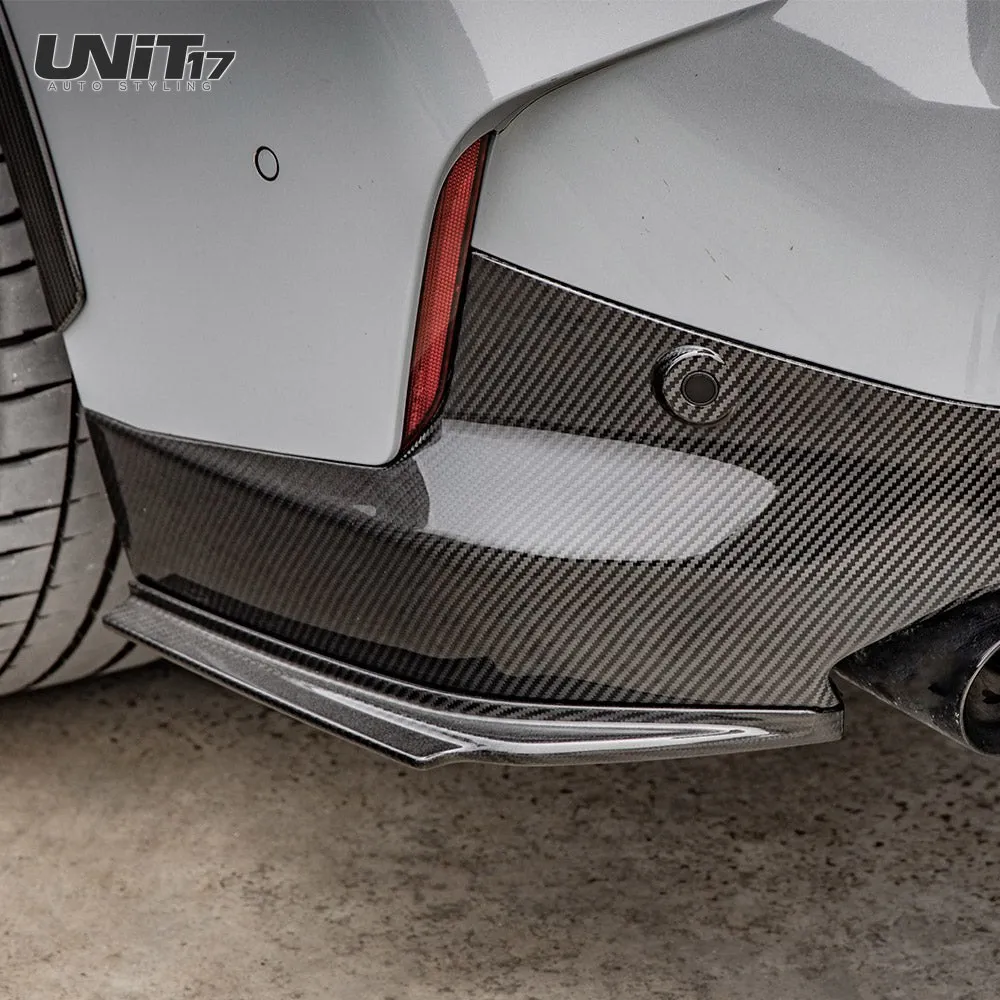 Close-up of a G42 rear spat beneath carbon bumper trim beside the exhaust