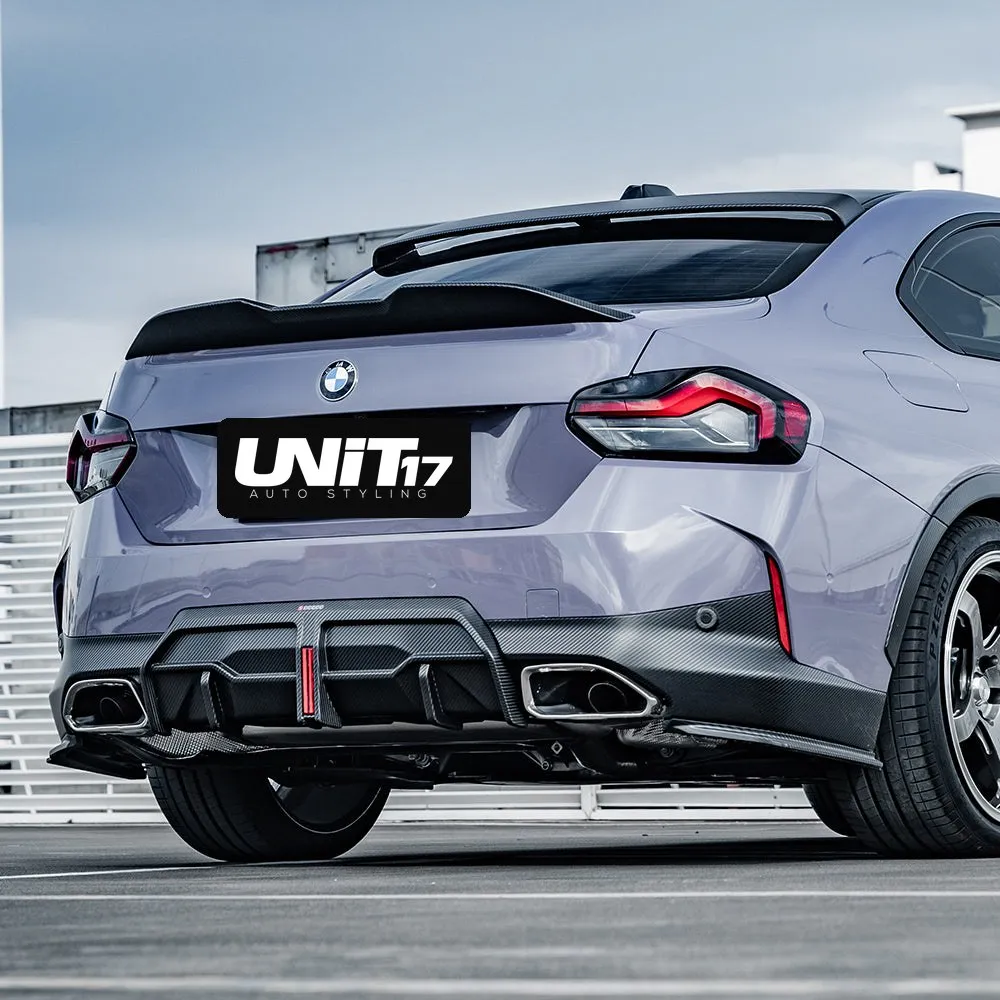 Low rear three-quarter view of a BMW G42 with carbon rear spats
