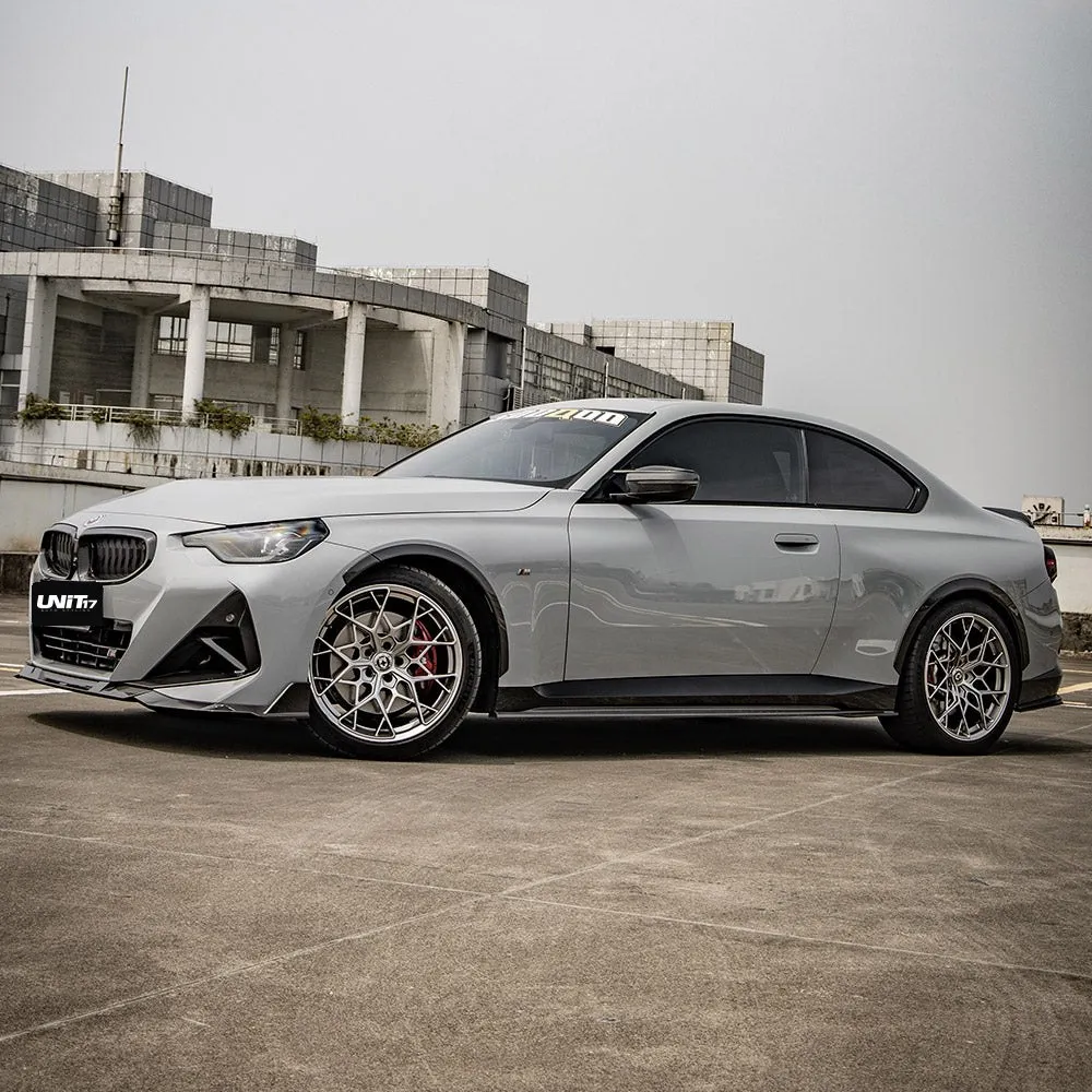 Gray BMW G42 2 Series with carbon side skirts installed