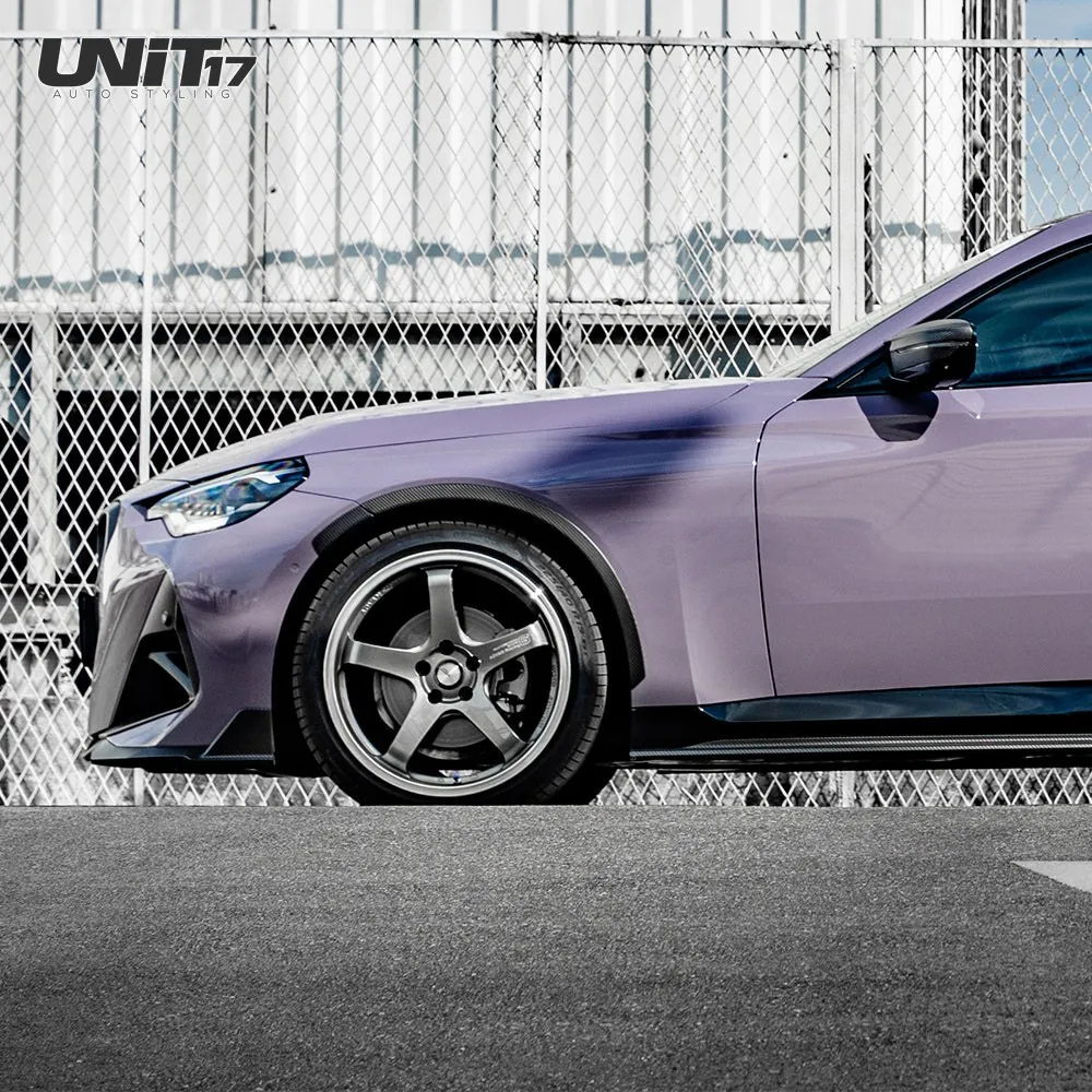 Front side view of a purple BMW G42 with carbon side skirt